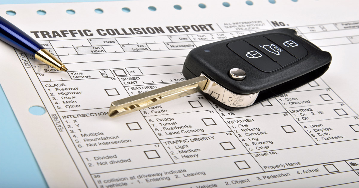 Traffic collision report paperwork with car key