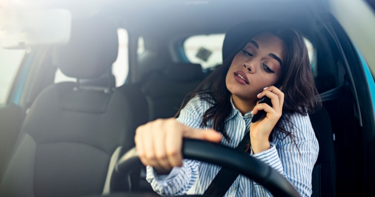 woman on phone while driving