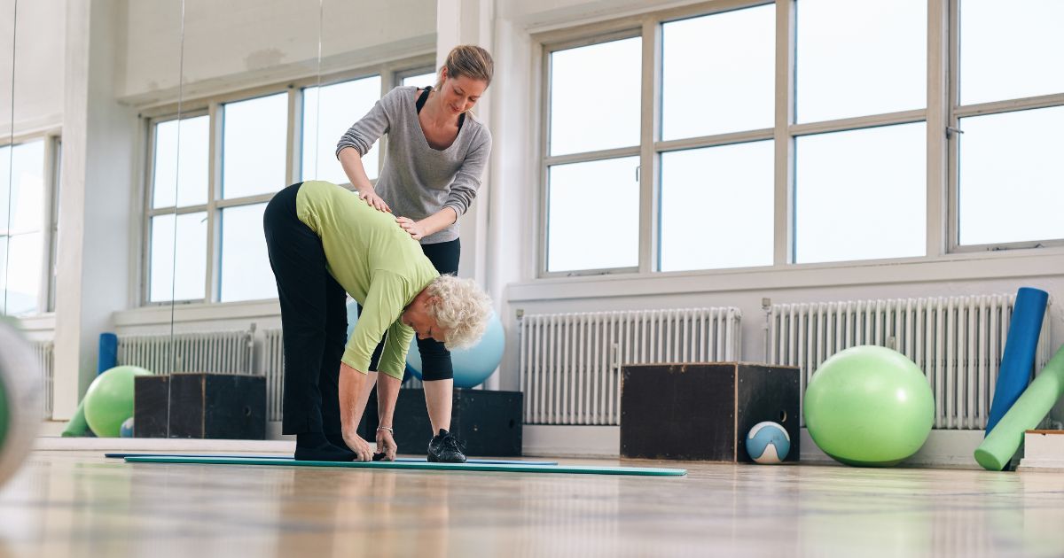 physical therapist helping patient with injuries.